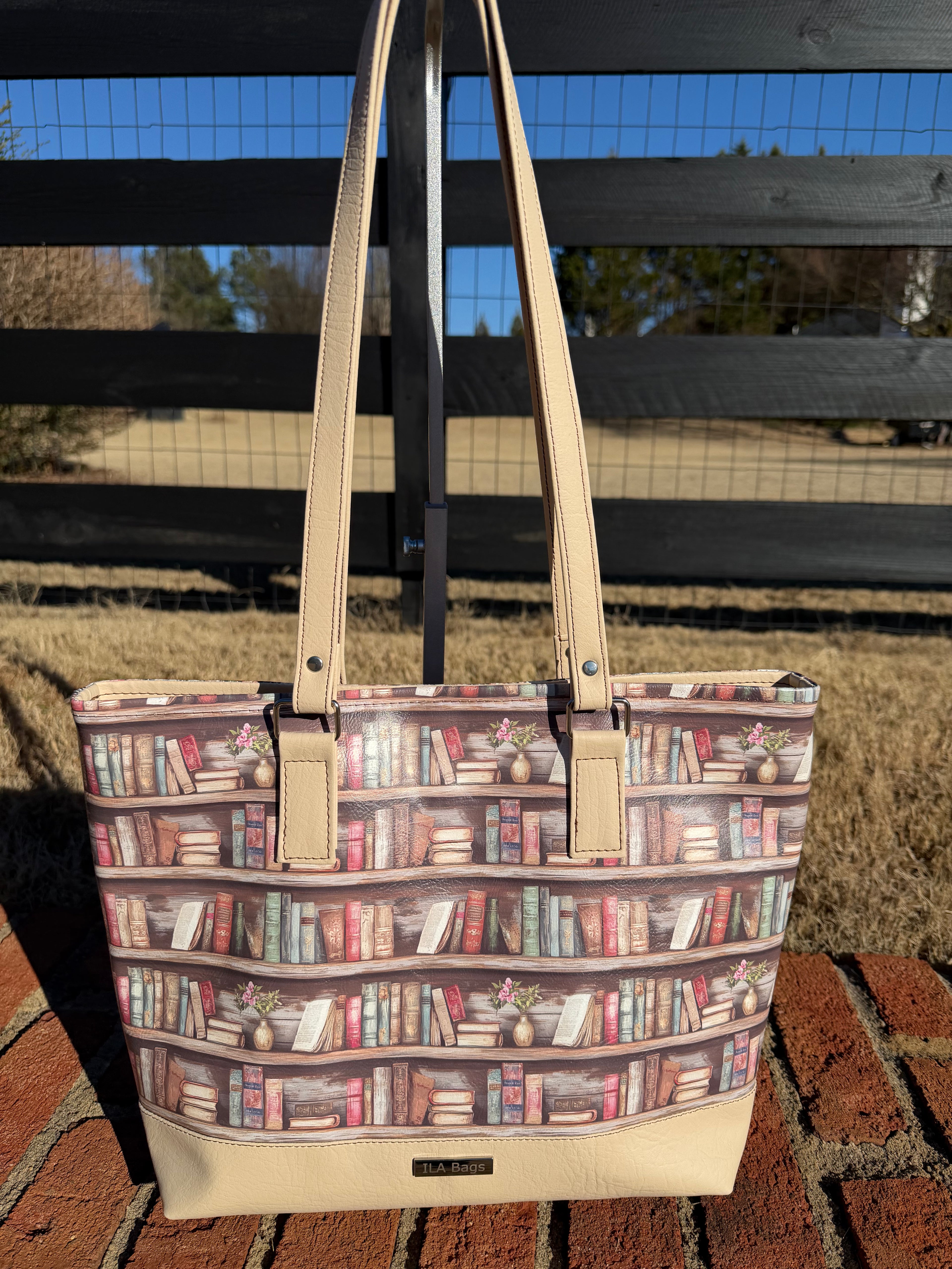 Tote bag with bookshelf pattern on a brick surface